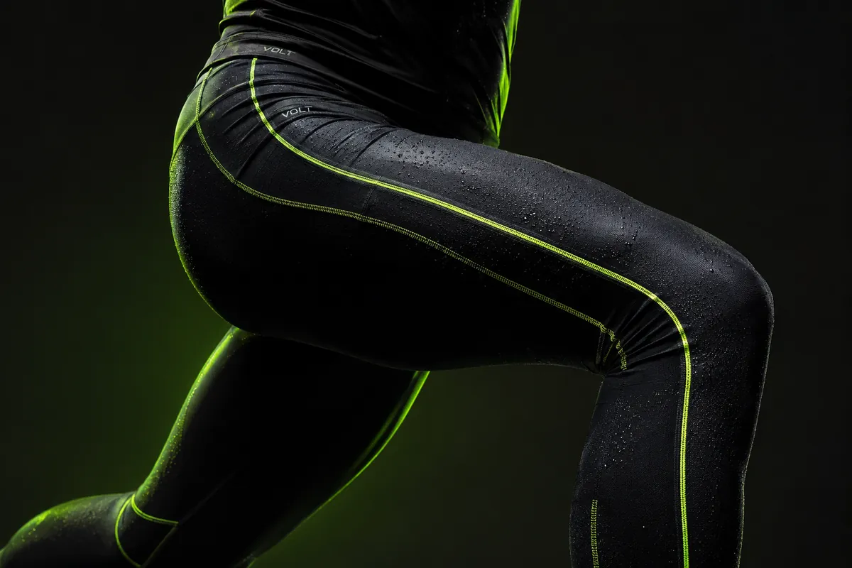 Velocity Compression Tight — black compression tights with volt green seam mapping, beaded with rain